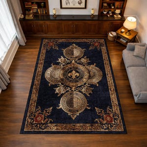 May include: A rectangular navy blue area rug with an ornate design. The rug features a central emblem with a fleur-de-lis and surrounding circular medallions in gold. The border and accents are also gold, with red floral details.
