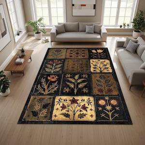 May include: A large, rectangular area rug with a dark background and a repeating pattern of floral and botanical designs in shades of gold, red, and green. The rug is placed in a living room with light-colored furniture and hardwood floors.