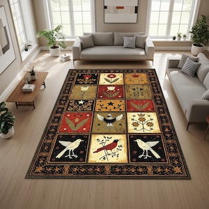 May include: A large area rug with a patchwork design featuring floral and bird motifs in a variety of colors. The rug has a black border with an intricate pattern and is placed in a living room setting.