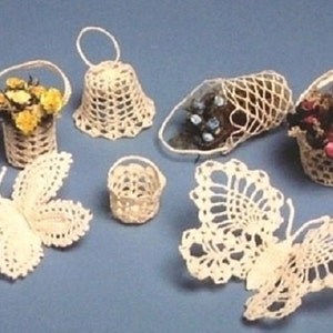 May include: A set of crocheted baskets and butterflies. The baskets are filled with small flowers and are made in a variety of shapes and sizes. The butterflies are delicate and intricate.