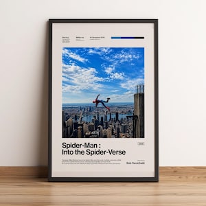 May include: Framed poster featuring a scene from "Spider-Man: Into the Spider-Verse." The image shows Spider-Man falling from a building against a backdrop of a city skyline and a blue sky with clouds. The poster includes the film's title and credits.