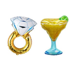 May include: Two foil balloons: a gold ring with a large diamond and a margarita glass. The diamond is white with blue accents. The margarita glass is yellow with a green lime slice and a blue base.