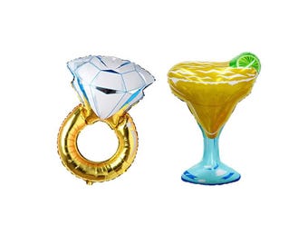 May include: Two foil balloons: a gold ring with a large diamond and a margarita glass. The diamond is white with blue accents. The margarita glass is yellow with a green lime slice and a blue base.