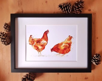 May include: A framed watercolor painting of two brown chickens. The chickens are facing each other, with one looking to the side and the other looking down. The painting is on a white background and is framed in a black frame.