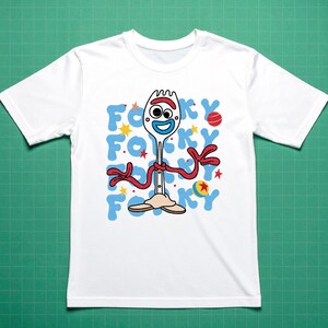 May include: White t-shirt featuring a cartoon image of Forky from Toy Story. The design includes Forky's face, arms, and legs, with the word "Forky" in blue letters. Red, yellow, and blue accents complete the design.