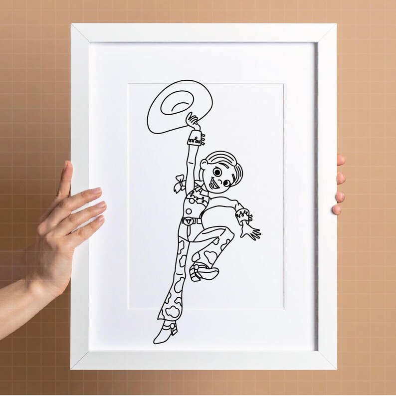 May include: Black and white line art print of a cartoon cowgirl holding a hat above her head. The cowgirl is wearing a patterned outfit and boots. The artwork is framed in a white rectangular frame.