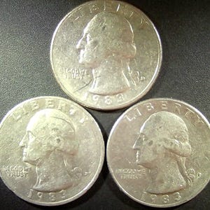 May include: A set of three ceramic mugs with a speckled, matte finish. The mugs are in shades of cream, light gray, and dark gray. Each mug has a simple, modern design and a rounded handle.