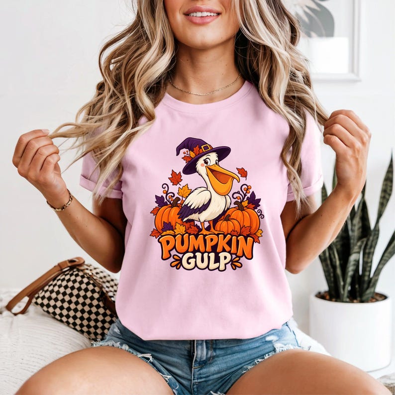 A whimsical illustration of a pelican wearing a purple witch hat, surrounded by orange pumpkins and autumn leaves, with the text PUMPKIN GULP in bold glossy orange letters.