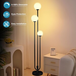 May include: A black floor lamp with three spherical, white light bulbs. The lamp has a sleek, modern design with a round base and a curved support structure. The image also shows text that says "3 Bulbs Included", "0-100% Dimmable", "Eyes Protection", and "Easy Installation".