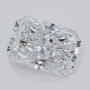 May include: A radiant-cut diamond with a rectangular shape. The colorless gemstone has many facets that reflect light, creating a brilliant sparkle. The diamond is set against a light gray background.