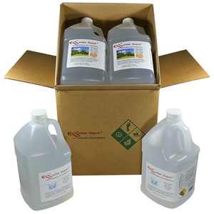 May include: A cardboard box containing four clear plastic gallon jugs of "Essential Depot" Greener Life Essentials. The box is open and two jugs are sitting outside the box.