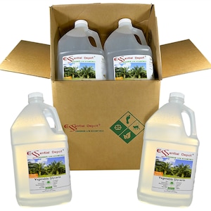 May include: Four clear plastic gallon jugs of vegetable glycerin in a brown cardboard box. The jugs have a white label with the text "Essential Depot" and "Greener Life Essentials" in green text. The jugs are labelled "Vegetable Glycerin".