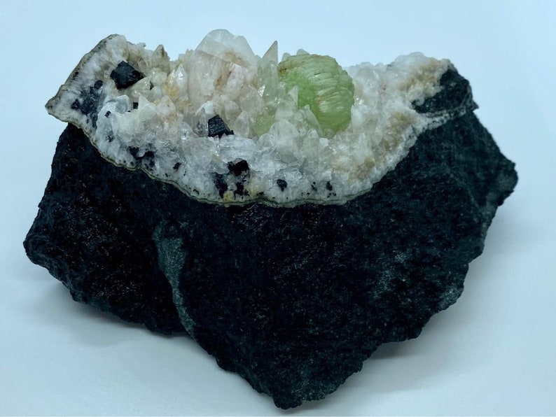 Babingtonite Crystals and Calcite Crystals on the Matrix Prehnite Botryoidal Crystal