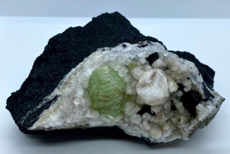 Babingtonite Crystals and Calcite Crystals on the Matrix Prehnite Botryoidal Crystal