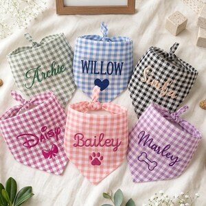 May include: Six triangular pet bandanas in various gingham patterns including sage green, blue, black, pink, peach, and lavender. Each bandana features embroidered names: Archie, Willow, Simba, Daisy, Bailey, and Marley, with small icons.