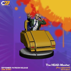May include: A yellow and black collectible figure of a bald man in a green suit, seated in a yellow chair. The figure is on a 35mm base. The text "The HEAD-Master" is visible. The image also includes the text "SEPTEMBER PATREON RELEASE LINK IN BIO".