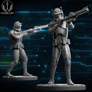 May include: Two gray, detailed figurines of soldiers in futuristic armor, holding rifles. The figures stand on circular bases, with the Wardlade Studio logo in the upper left corner. The background features a blue, digital-style design.