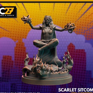 May include: A detailed figurine of a woman in a seated pose, with arms outstretched, holding intricate objects. The figure is surrounded by flames and sits on a circular base. The text "SCARLET SITCOM" is visible.