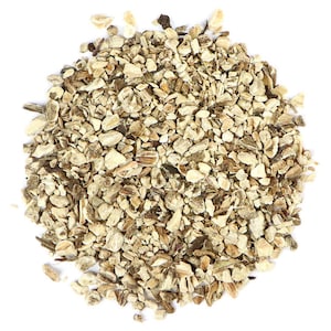 May include: A close-up view of a pile of dried, light brown, and beige burdock root pieces.