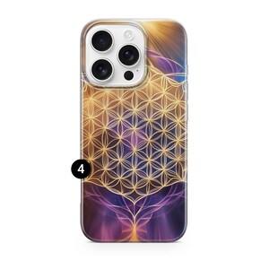 May include: A phone case with a vibrant design featuring a golden geometric pattern over a purple and orange background. The case has a clear border and a camera cutout. The design includes a stylized tree-like shape at the bottom.