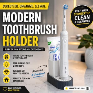 May include: A white electric toothbrush and a tube of toothpaste standing in a two-section, ribbed, dark gray and white plastic holder. The holder features a rectangular base with a vertical compartment for the toothbrush and a separate slot for the toothpaste tube, designed to keep bathroom essentials organized.