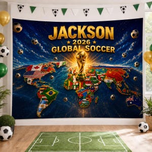 May include: A large rectangular wall tapestry featuring a dark blue space background with a world map composed of various national flags. The text JACKSON 2026 GLOBAL SOCCER appears in gold, centered above a golden soccer trophy illustration.