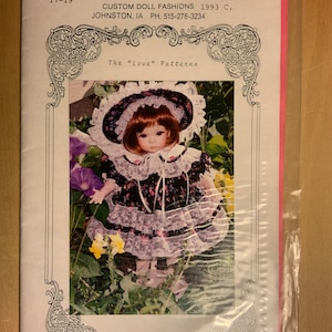 May include: A doll pattern for a 17-inch doll wearing a black and white dress with a white lace trim and a white hat with black floral accents. The pattern is called "The "Love" Patterns" and is by Angela Coriatti.