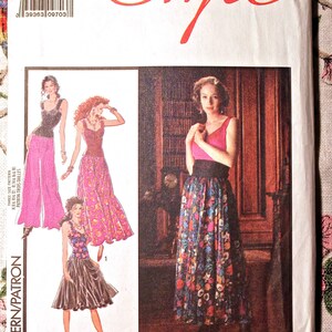 May include: A sewing pattern for a dress with three different styles. The pattern is for sizes 14, 16, and 18. The pattern is called "Style" and has the number 1654 on it.