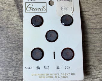 May include: A card with six brown and white buttons on it. The card is labelled "Grants" and has the price "69¢ each". The buttons are 5/8 inch in size.