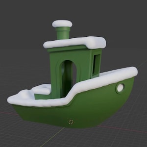 May include: A green toy boat with white accents, including a cabin and a smokestack. The boat has a rounded hull and is covered in a layer of white, possibly snow. The boat has a circular window on the side.