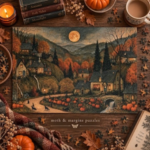 May include: A rectangular jigsaw puzzle featuring an autumn landscape with a full moon, stone cottages, and a pumpkin patch. The scene includes a winding path, trees with orange foliage, and a small bridge. The text reads moth & margins puzzles.