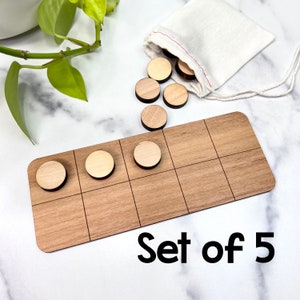 May include: A set of five wooden counting chips with a wooden grid board. The chips are in a small white drawstring bag. The board has a grid of 6 squares.  Set of 5.