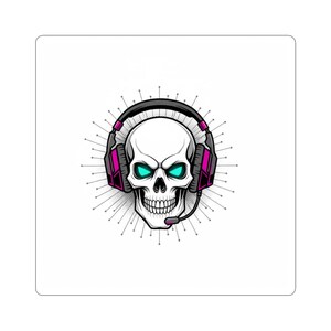 May include: A white skull illustration wearing a black and pink headset with a microphone. The skull has glowing teal eyes and is surrounded by radiating lines, creating a gaming or tech-themed design.