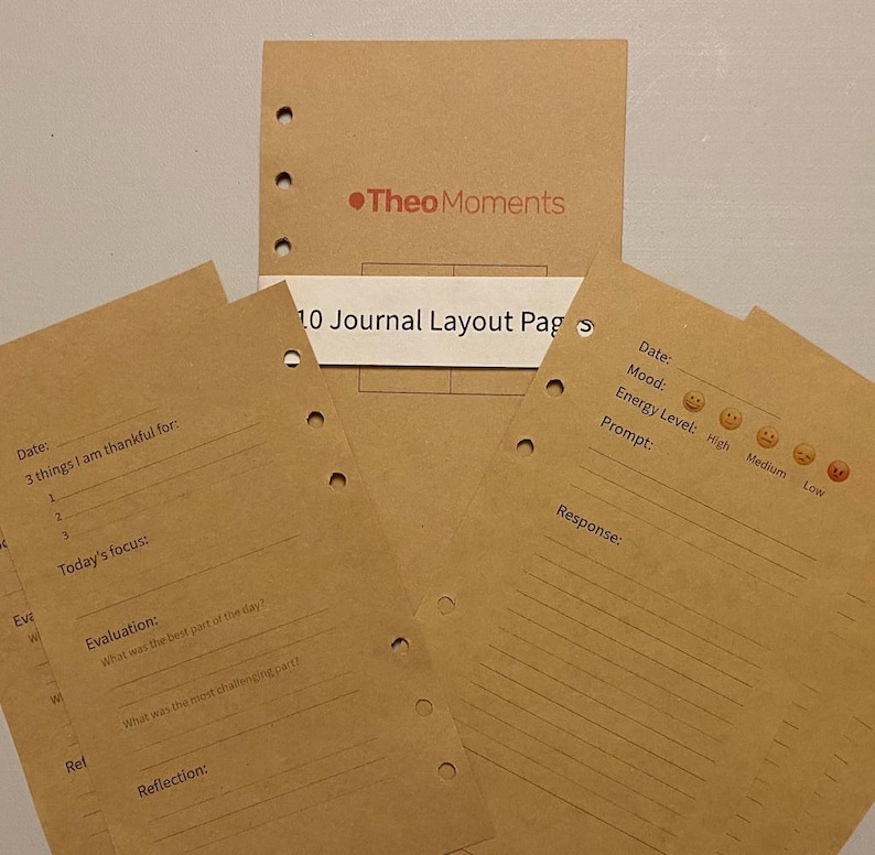 May include: Kraft paper journal layout pages with pre-printed prompts for daily reflection. The pages include sections for gratitude, focus, evaluation, and reflection. The journal pages are designed to be inserted into a binder. The top of the journal says "Theo Moments".