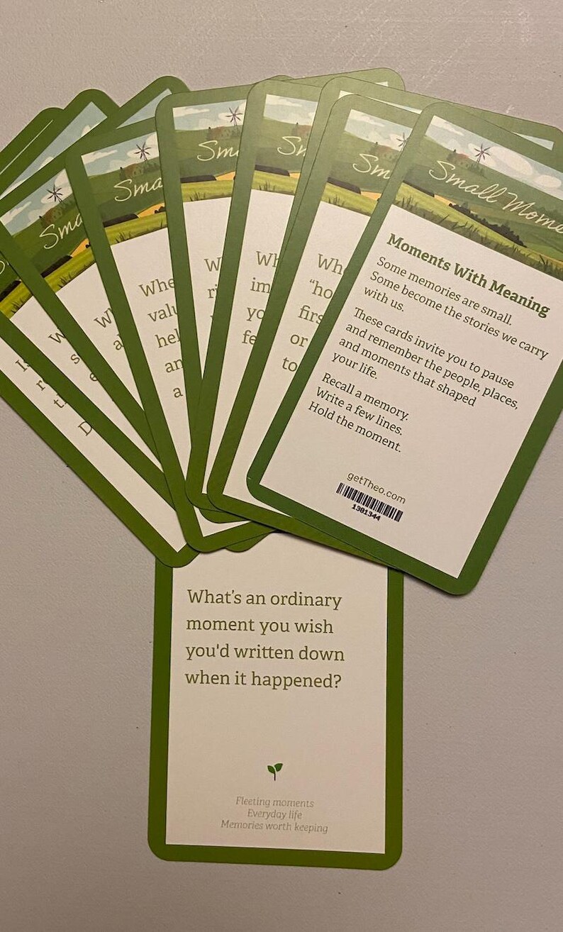 May include: A collection of green and white cards with the words "Small Moments" and "Moments With Meaning." The cards feature prompts to recall memories and write about them. The bottom card asks, "What's an ordinary moment you wish you'd written down when it happened?"
