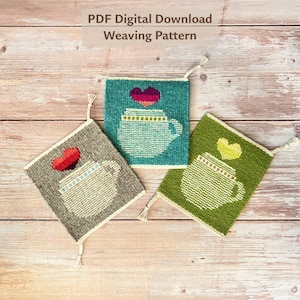 May include: Three woven square coasters with a coffee cup design and a heart above it. The coasters are in teal, gray, and green, with white trim and tassels. The text "PDF Digital Download Weaving Pattern" is at the top.