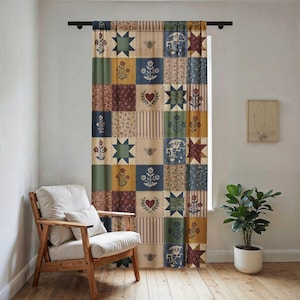 May include: A patchwork curtain with a variety of patterned squares in shades of blue, green, red, and yellow. The squares feature floral, star, and heart designs. The curtain hangs from a black rod in front of a window.