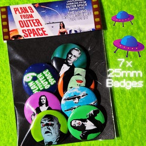 May include: A set of seven 25mm circular pin-back badges featuring imagery from the film Plan 9 from Outer Space. The badges display various black and white character portraits, flying saucers, and movie title text on colourful backgrounds.