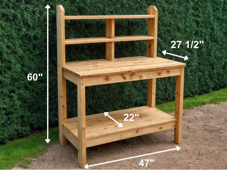 May include: A wooden potting bench with a natural finish. It features a top work surface, a lower shelf, and an upper shelf with two compartments. The bench is 60 inches tall, 47 inches wide, and 27.5 inches deep, with a 22-inch shelf.