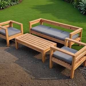 May include: Outdoor wooden furniture set with a sofa, two armchairs, and a coffee table. The set features a natural wood finish and gray cushions. The furniture is arranged on a stone patio with a green lawn in the background.