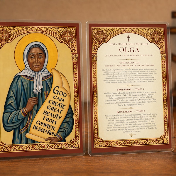 Könnte beinhalten: Eine zweiseitige religiöse Tafel mit einer Ikone von Mutter Olga auf der einen Seite mit dem Text 'God can create great beauty from complete desolation' und einem biografischen Text über die heilige Mutter Olga von Kwethluk auf der anderen.