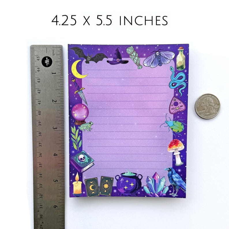 May include: A lined notepad, 4.25 x 5.5 inches, with a purple gradient background and a border of mystical illustrations. The border includes a bat, witch's hat, moon, crystal ball, frog, and other magical elements. A ruler and a quarter are next to the notepad.