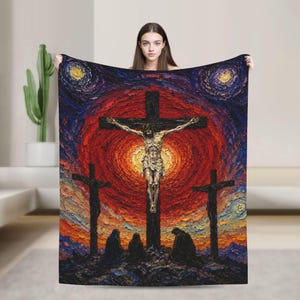 May include: A rectangular throw blanket featuring a textured, impasto-style painting of the crucifixion. The central figure is on a cross against a vibrant red and orange sunburst, flanked by two smaller crosses and three kneeling figures below.