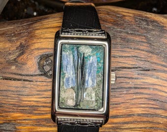 Vivianite, Kyanite, and Topaz set in UV kryptonite + Hyalite opal nugget in repurposed watch.