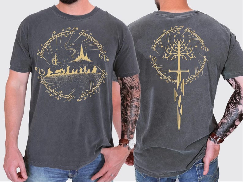 two different views of a man wearing a gray t-shirt with a graphic design featuring a castle, a tree, and a sword.