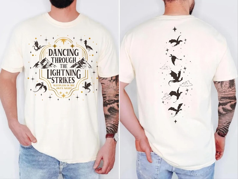 A white t-shirt with a graphic design featuring a dragon and the text "DANCING THROUGH THE LIGHTNING STRIKES ONY NIGHT" printed on it.