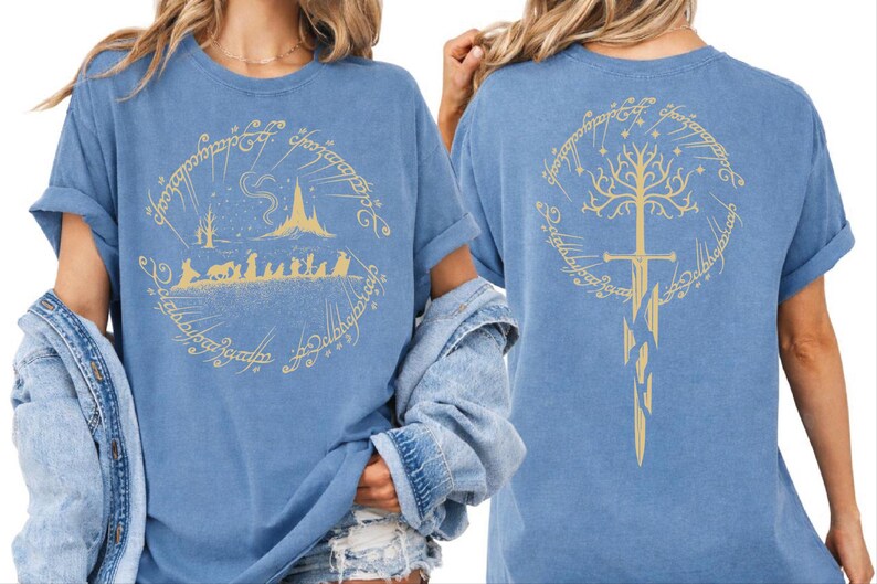 two women wearing blue t-shirts with gold designs on the back.