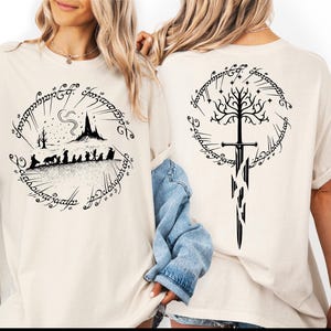 two women wearing white t-shirts with black designs featuring characters and symbols from the Lord of the Rings series.