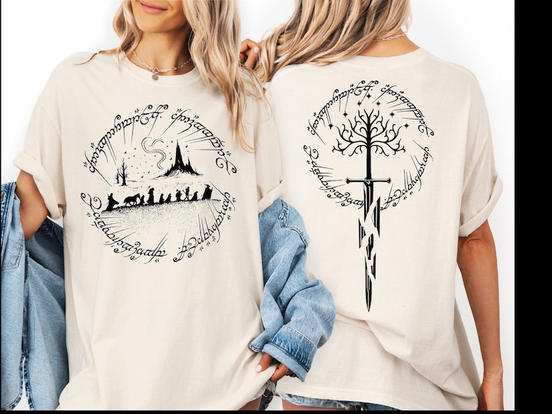 two women wearing white t-shirts with black designs featuring characters and symbols from the Lord of the Rings series.