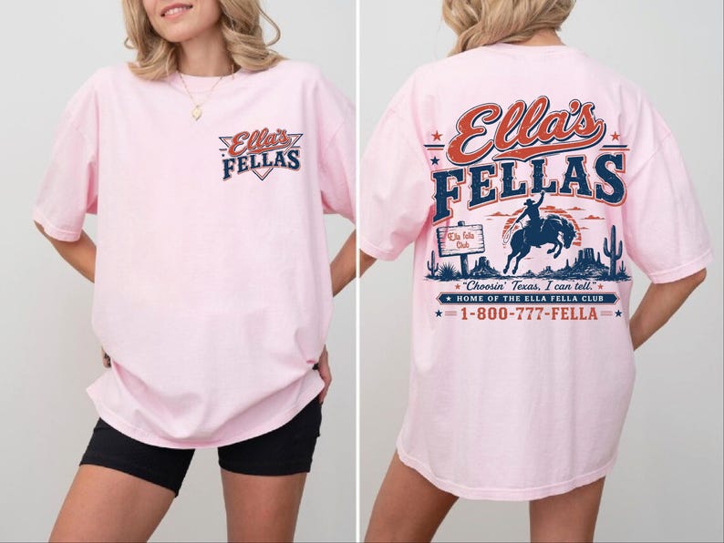 A woman wearing a pink t-shirt with a graphic design on the back.